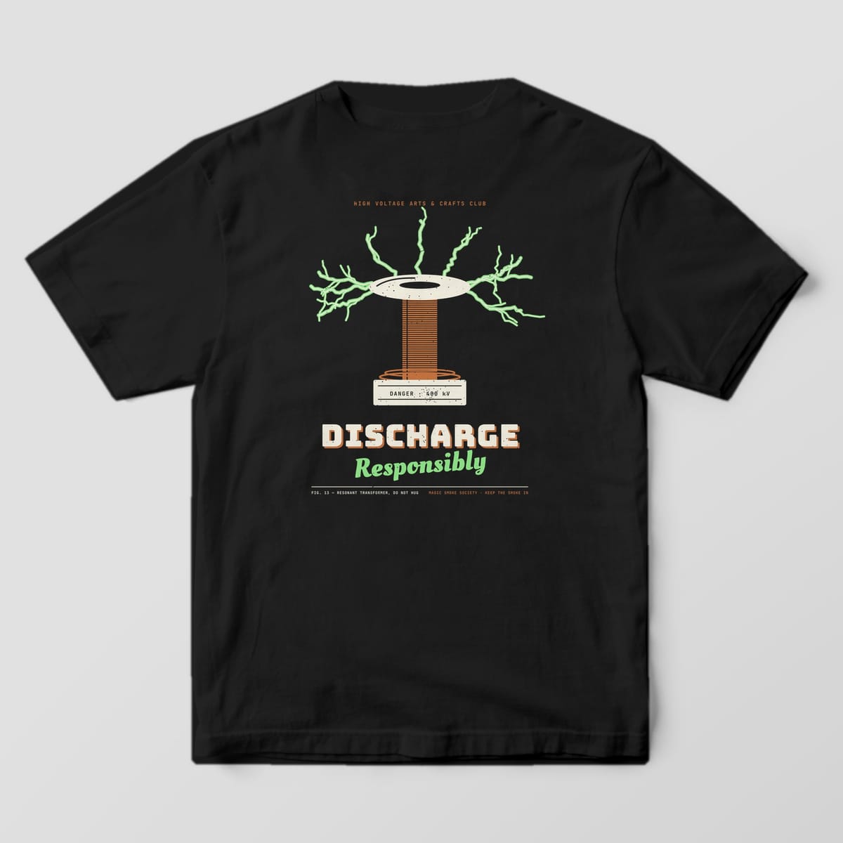 Back of a black Comfort Colors 1717 tee with a coil and green arcs print reading Discharge Responsibly.