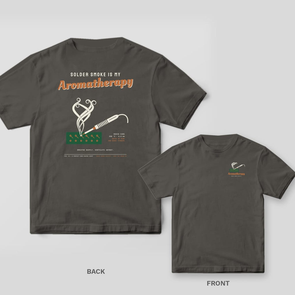Pepper tee shown back and front: back has a soldering iron on a green circuit board with curling smoke under Aromatherapy script; front has a small version.