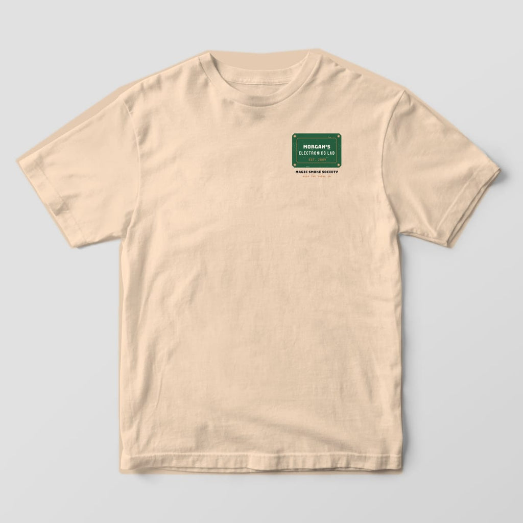 Front of an ivory Comfort Colors 1717 tee with a small green plaque reading Morgan's Electronics Lab on the left chest.