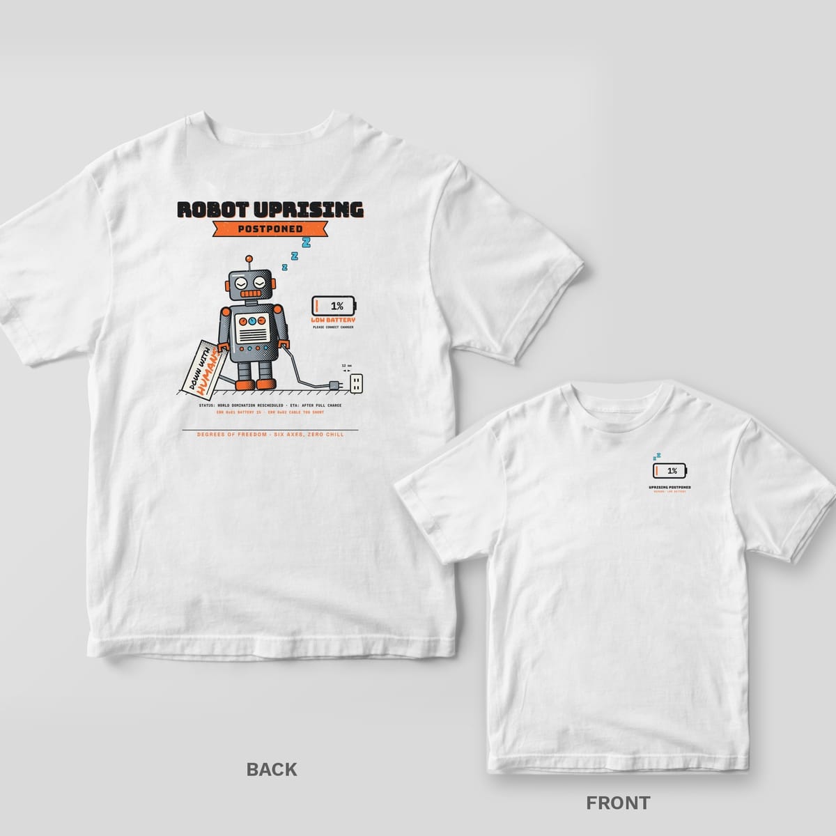 White tee shown back and front: back has a sleeping grey tin robot with a dropped Down With Humans sign under Robot Uprising Postponed; front has a 1% battery icon.