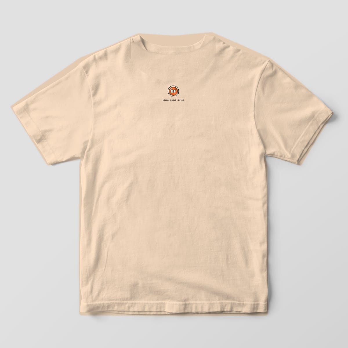 Back of an ivory Comfort Colors 1717 tee with a small DF monogram at the back neck.