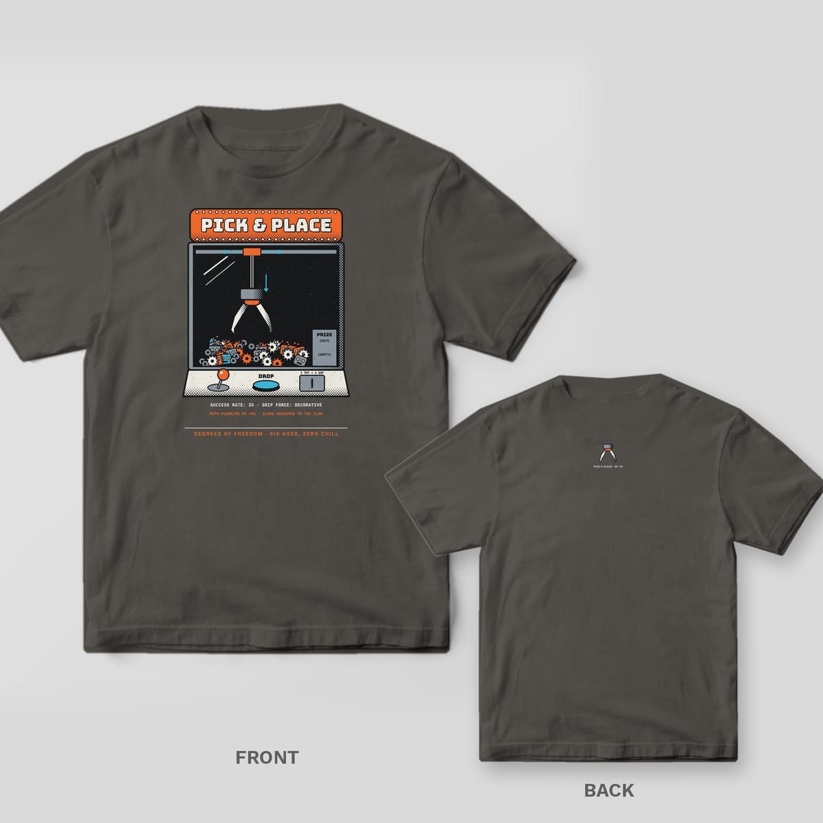 Pepper tee shown front and back: front has an arcade claw machine labeled Pick & Place with a claw over a pile of small robots; back has a small claw icon at the neck.