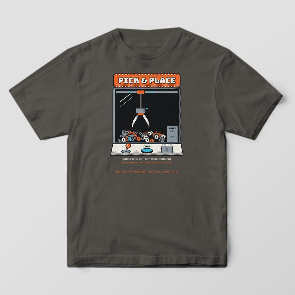 Front of a pepper Comfort Colors 1717 tee with a large Pick & Place claw machine.
