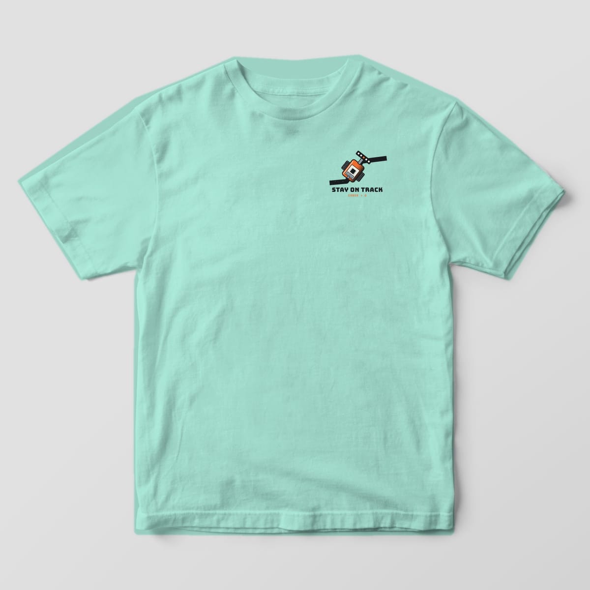 Front of a chalky mint Comfort Colors 1717 tee with a small line-following robot on a black track on the left chest.