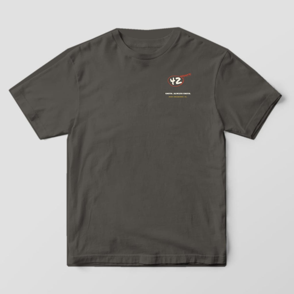 Front of a pepper Comfort Colors 1717 tee with a small circled 42 with the word what on the left chest.