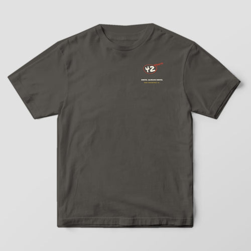 Front of a pepper Comfort Colors 1717 tee with a small circled 42 with the word what on the left chest.