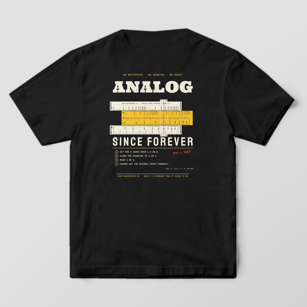 Back of a black Comfort Colors 1717 tee with a cream and yellow slide rule with real log scales between the words Analog and Since Forever.