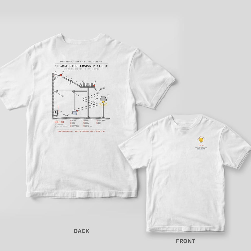 White tee shown back and front: back has a vintage patent drawing of a chain-reaction contraption that flips a light switch; front has a small yellow lit light bulb.