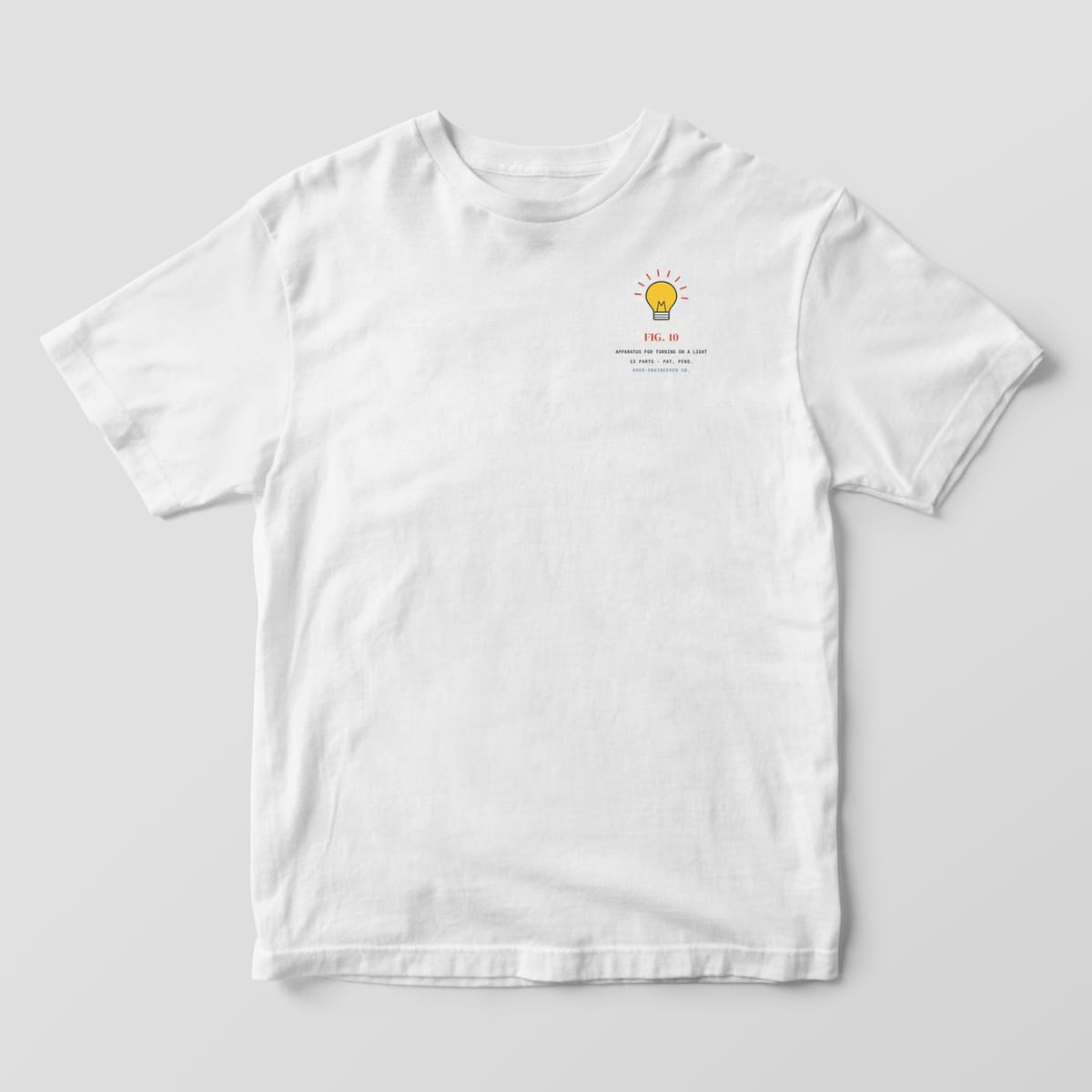 Front of a white Comfort Colors 1717 tee with a small yellow lit light bulb on the left chest.