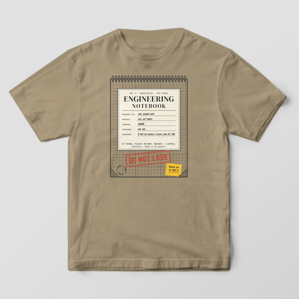 Front of a khaki Comfort Colors 1717 tee with a full-front spiral engineering notebook cover with a red Do Not Lose stamp.