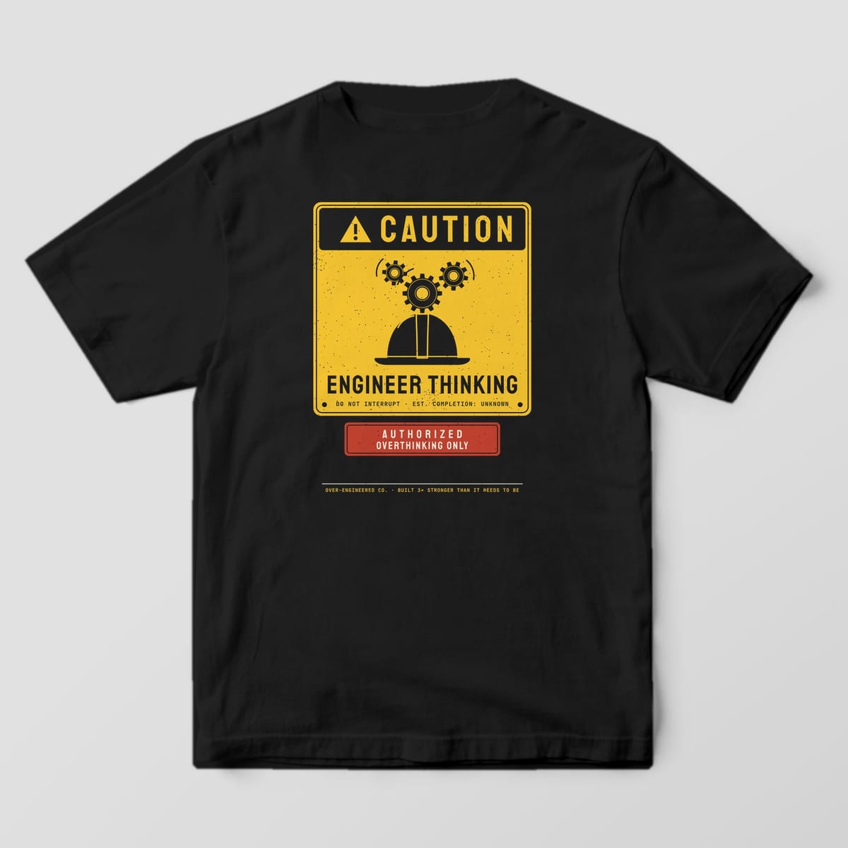 Back of a black Comfort Colors 1717 tee with a big yellow Caution sign with a hard hat and gears reading Engineer Thinking.