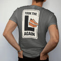 Man wearing a Pepper tee, seen from the back: a crumpled raffle ticket stamped with a giant L beside a sad shoebox, with Took The L above and Again below, as a two-ink streetwear graphic in off-white and orange.