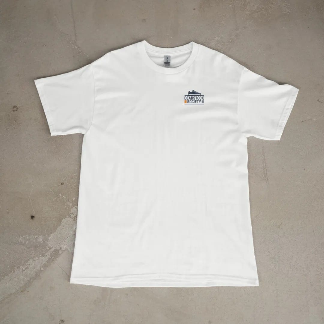 Front of a White tee laid flat, with the small Deadstock Society logo on the left chest.