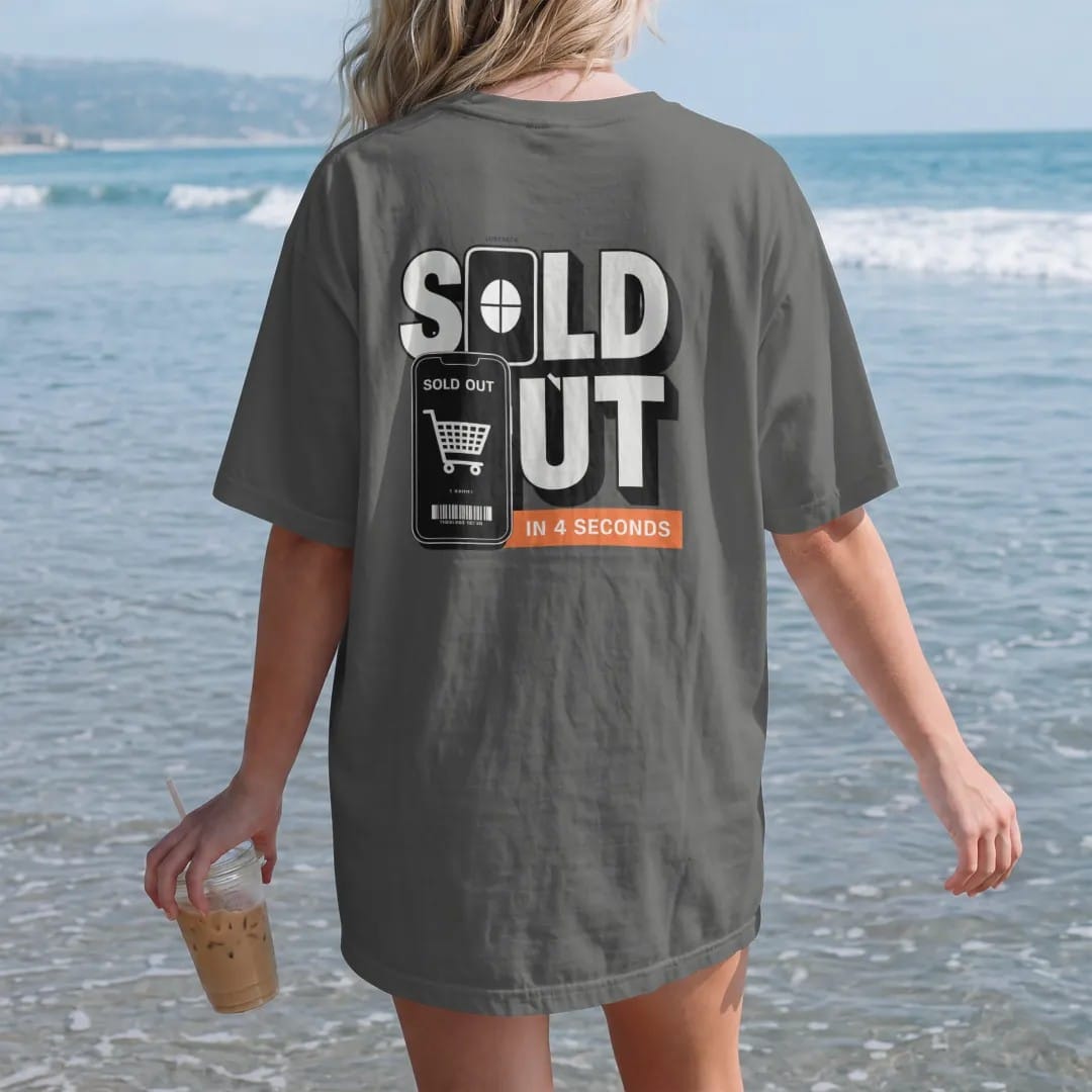 Woman on the beach in a Pepper tee, back view: a frozen countdown clock and a phone with an empty cart under Sold Out and In 4 Seconds, as a two-ink streetwear graphic in off-white and orange.