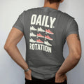 Man wearing a Pepper tee, seen from the back: a weekly planner grid of seven different sneakers under Daily and above a big Rotation, as a two-ink streetwear graphic in off-white and orange.