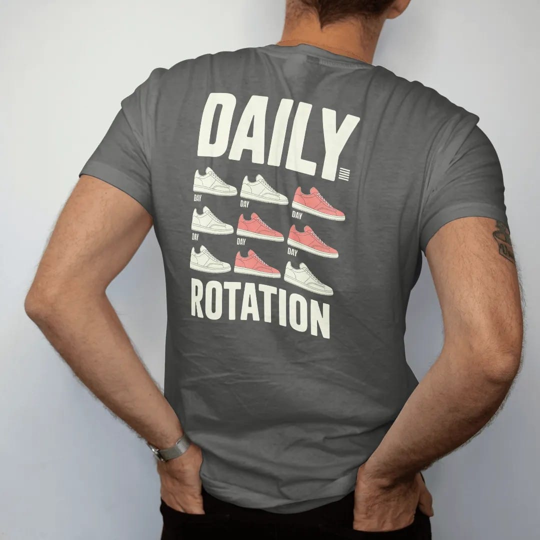 Man wearing a Pepper tee, seen from the back: a weekly planner grid of seven different sneakers under Daily and above a big Rotation, as a two-ink streetwear graphic in off-white and orange.