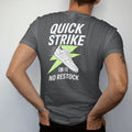 Man wearing a Graphite tee, seen from the back: a sneaker bursting through a lightning bolt with speed lines under Quick Strike and stamped No Restock, as a two-ink streetwear graphic in off-white and lime.