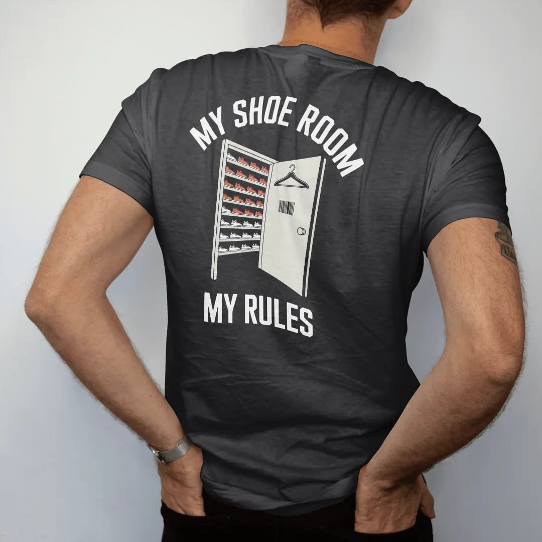 Man wearing a Black tee, seen from the back: a doorway into a room of lit sneaker shelves with a door hanger, under My Shoe Room and My Rules, as a two-ink streetwear graphic in off-white and orange.