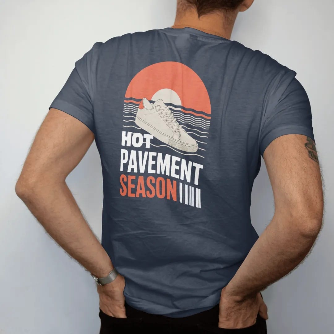 Man wearing a Midnight tee, seen from the back: a sneaker on sizzling asphalt with heat waves and a big sun, under wavy Hot Pavement and Season, as a two-ink streetwear graphic in off-white and orange.