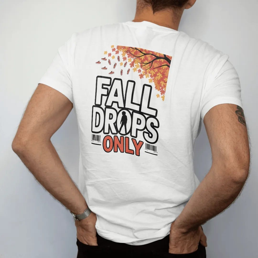 Man wearing a White tee, seen from the back: autumn leaves and tiny sneakers falling from a tree with Fall Drops arched above and Only below, as a two-ink streetwear graphic in off-white and orange.