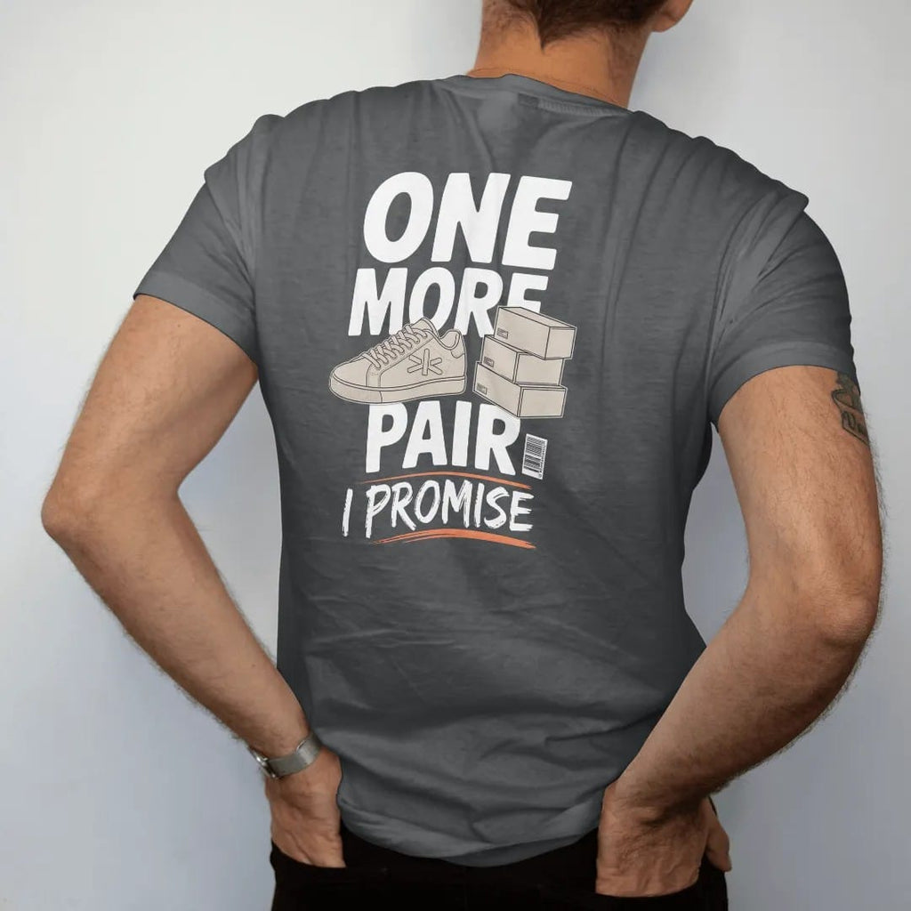 Man wearing a Graphite tee, seen from the back: a sneaker with crossed fingers beside a stack of delivery boxes, labeled One More Pair and a scrawled I Promise, as a two-ink streetwear graphic in off-white and orange.