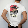 Man wearing a White tee, seen from the back: a caped hero sandwich flying over a night skyline under comic Hero Of and The Night letters, in halftone comic-pop red, yellow and cream.