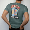 Man wearing a Blue Spruce tee, seen from the back: a frosty glass-door drink fridge full of cans with Ice Cold in frosted letters and In The Back below, in halftone comic-pop red, yellow and cream.
