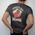 Man wearing a Black tee, seen from the back: a half-scratched ticket revealing stars and a coin under a dream cloud of a beach house, with Scratch-Off and Dreamer, in halftone comic-pop red, yellow and cream.