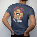 Man wearing a Navy tee, seen from the back: a steaming paper coffee cup with swirling autumn leaves under Light & Sweet script and Since Forever, in halftone comic-pop red, yellow and cream.
