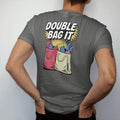 Man wearing a Pepper tee, seen from the back: two plastic bags nested and stuffed with groceries and a bottle peeking out, under Double Bag It, in halftone comic-pop red, yellow and cream.