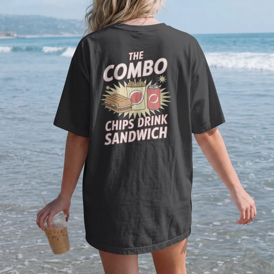 Woman on the beach in a Black tee, back view: a sandwich, a bag of chips and a soda can lined up with sparkles under The Combo and Chips Drink Sandwich, in halftone comic-pop red, yellow and cream.