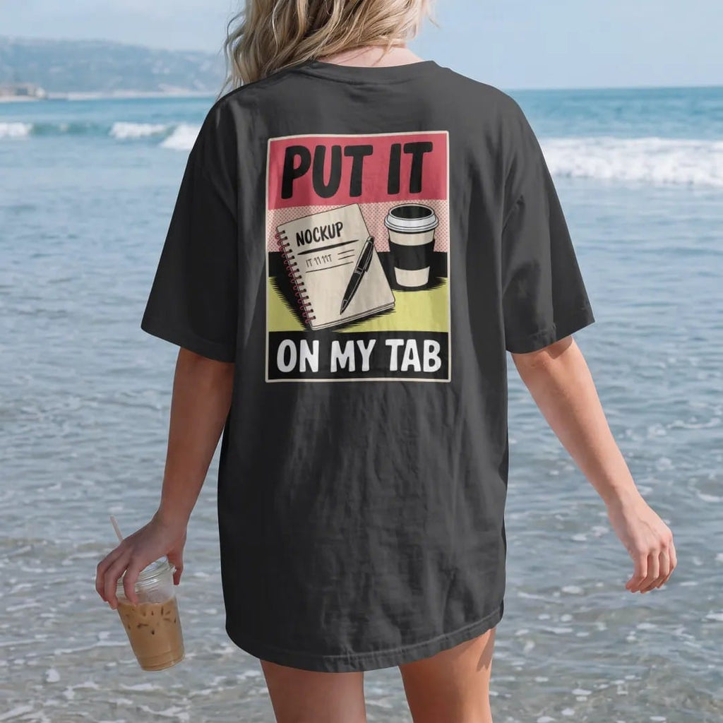 Woman on the beach in a Black tee, back view: a spiral notebook with tally marks and a pen beside a coffee cup, with Put It and On My Tab, in halftone comic-pop red, yellow and cream.