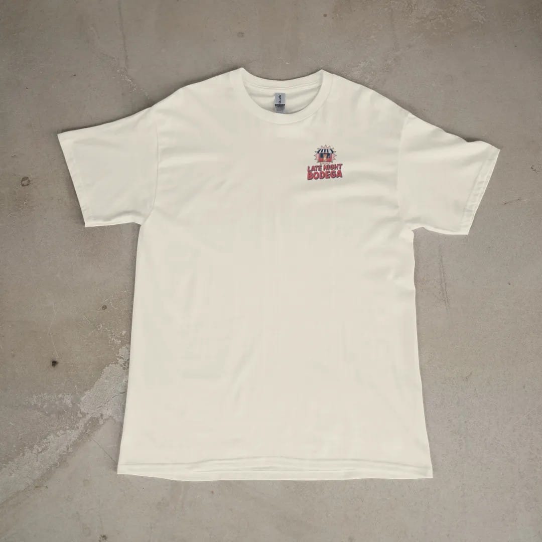 Front of a Ivory tee laid flat, with the small Late Night Bodega logo on the left chest.