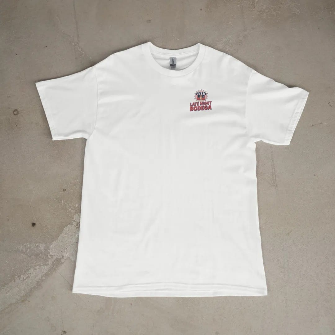 Front of a White tee laid flat, with the small Late Night Bodega logo on the left chest.