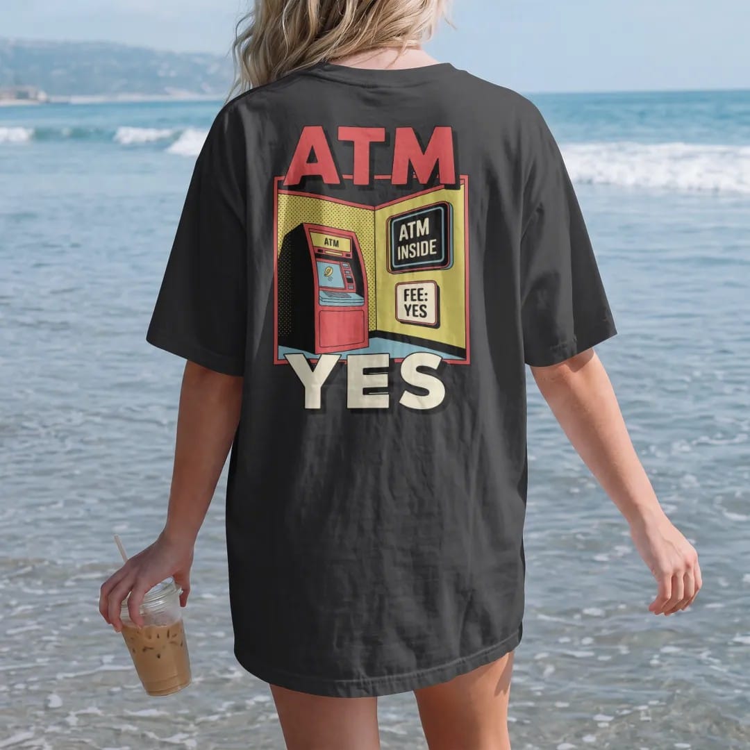 Woman on the beach in a Black tee, back view: a clunky ATM with a glowing screen and a flying coin under a neon ATM Inside sign and a Fee: Yes placard, in halftone comic-pop red, yellow and cream.