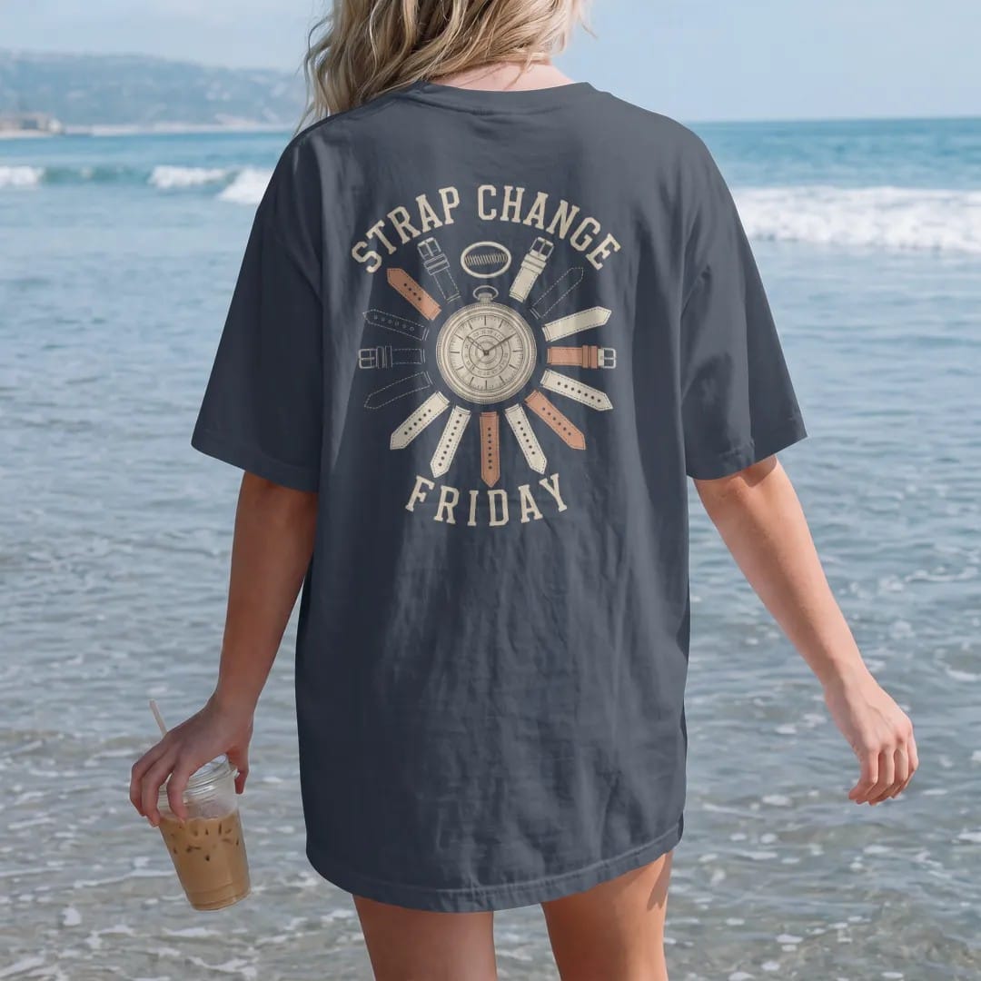 Woman on the beach in a Midnight tee, back view: a watch case with a spring bar tool and a fan of leather, rubber and canvas straps, under Strap Change and Friday, as a fine engraving in antique gold and cream.