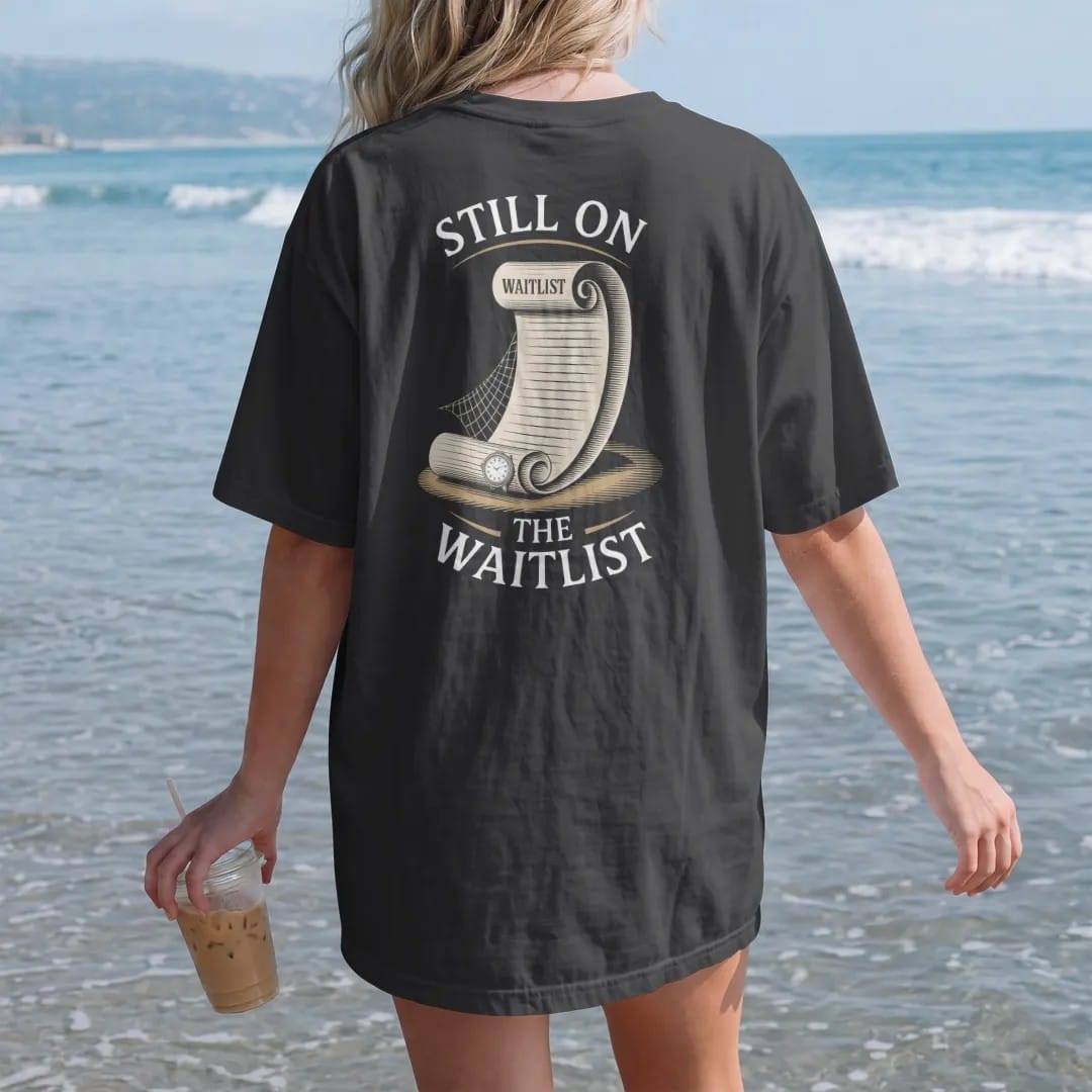 Woman on the beach in a Black tee, back view: a long waitlist scroll unrolling to a tiny watch and a cobweb, under Still On and The Waitlist, as a fine engraving in antique gold and cream.
