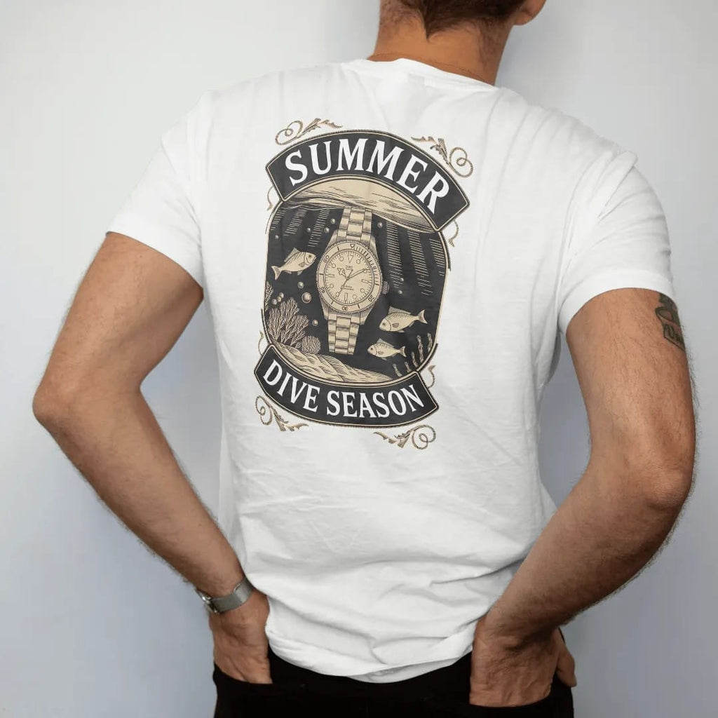 Man wearing a White tee, seen from the back: a dive watch underwater with a turned bezel, bubbles, sun rays and fish, under Summer and Dive Season, as a fine engraving in antique gold and cream.