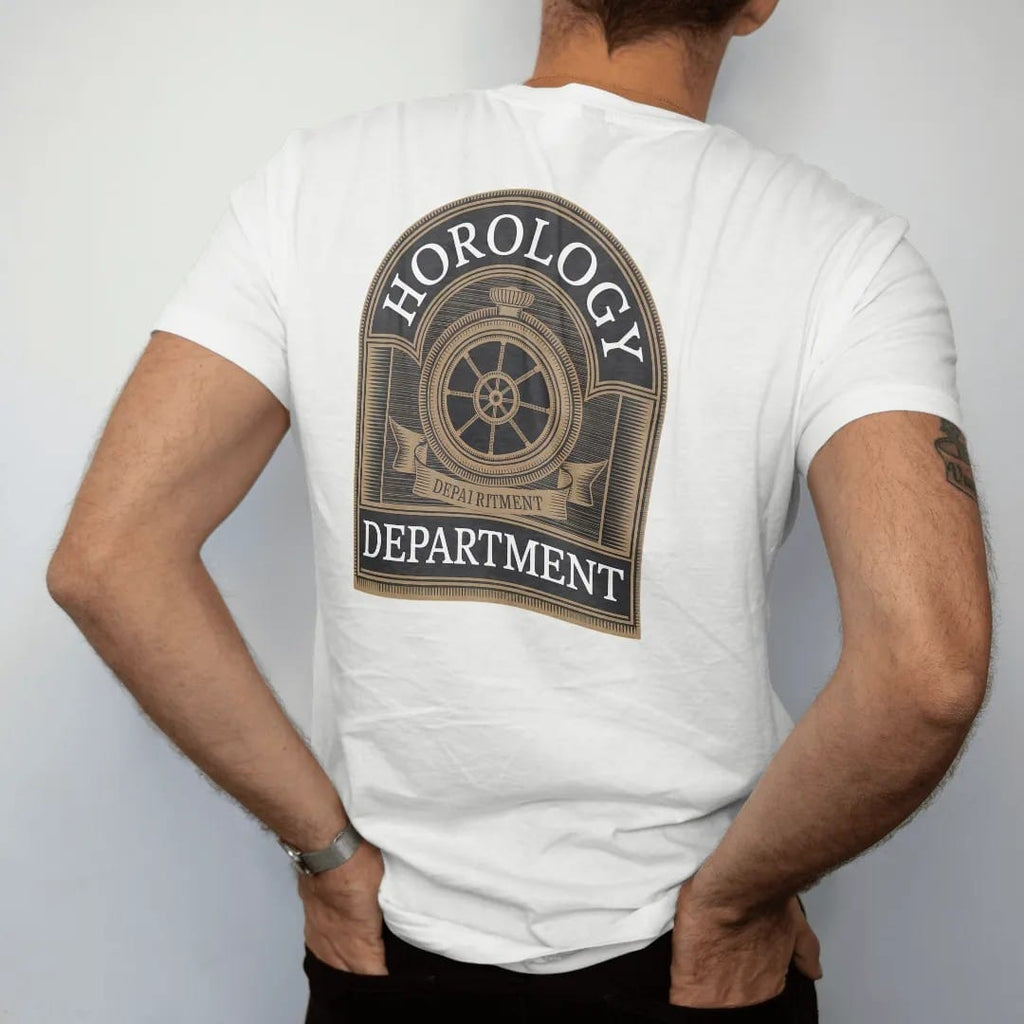 Man wearing a White tee, seen from the back: a collegiate crest with a gear and balance wheel mascot under arched Horology and Department, as a fine engraving in antique gold and cream.