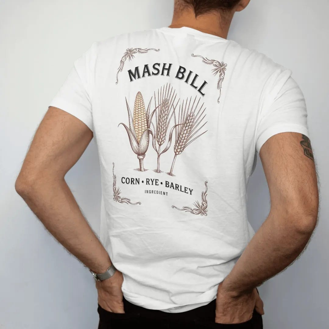 Man wearing a White tee, seen from the back: three engraved grain stalks of corn, rye and barley on a recipe card, with "MASH BILL" and "CORN · RYE · BARLEY", printed as a fine engraving in antique gold and warm cream.