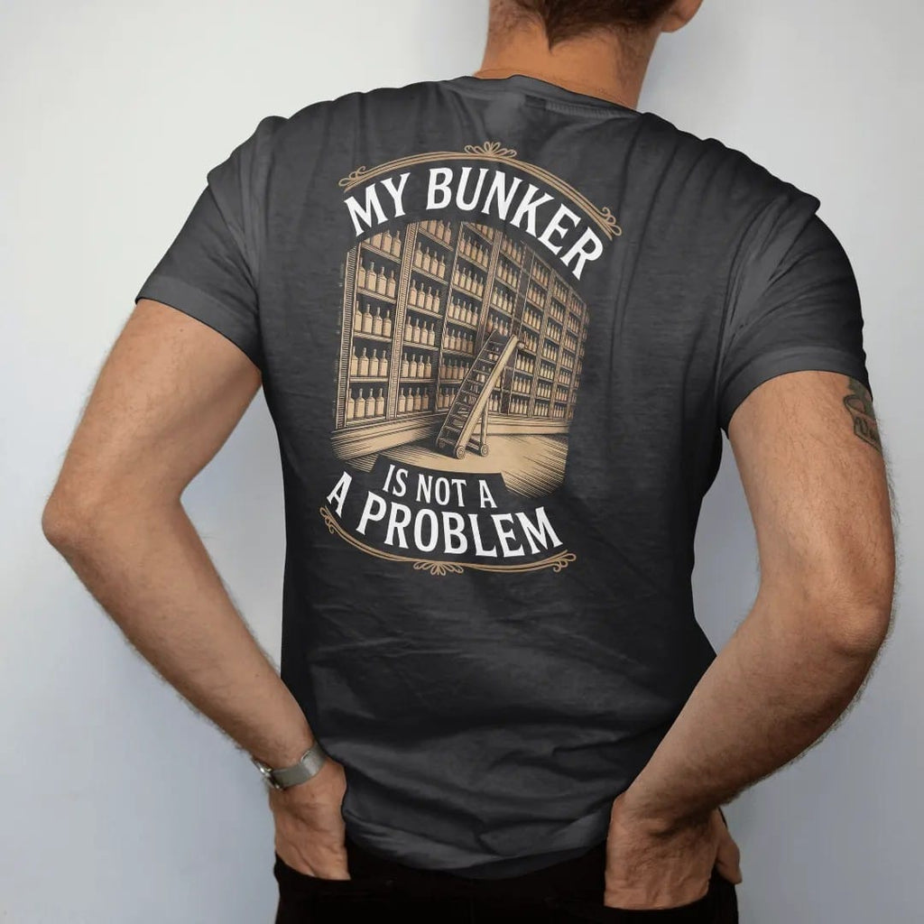 Man wearing a Black tee, seen from the back: a wall of shelves packed with whiskey bottles and a library ladder, with "MY BUNKER" and "IS NOT A PROBLEM", printed as a fine engraving in antique gold and warm cream.