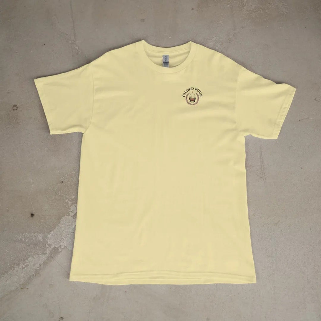 Front of a Butter tee laid flat, with the small Gilded Pour logo on the left chest.