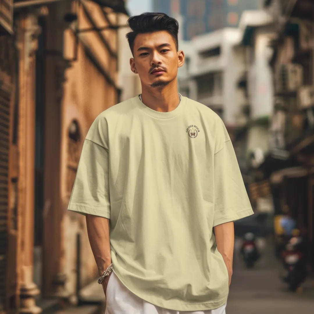 Man in a Butter tee on a city street, with the small Gilded Pour logo on the left chest.