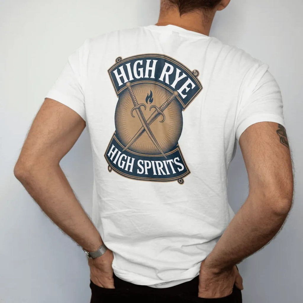 Man wearing a White tee, seen from the back: crossed rye stalks behind a small flame on a shield, with "HIGH RYE" and "HIGH SPIRITS" in condensed Victorian display capitals, printed as a fine engraving in antique gold and warm cream.
