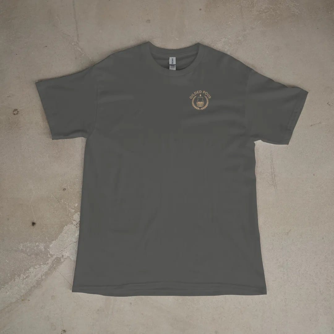 Front of a Pepper tee laid flat, with the small Gilded Pour logo on the left chest.