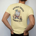 Man wearing a Butter tee, seen from the back: a whiskey smash with lemons and mint over sunburst rays, with "WHISKEY SMASH" and "SUMMER CLUB", printed as a fine engraving in oxblood, charred oak brown and antique gold.