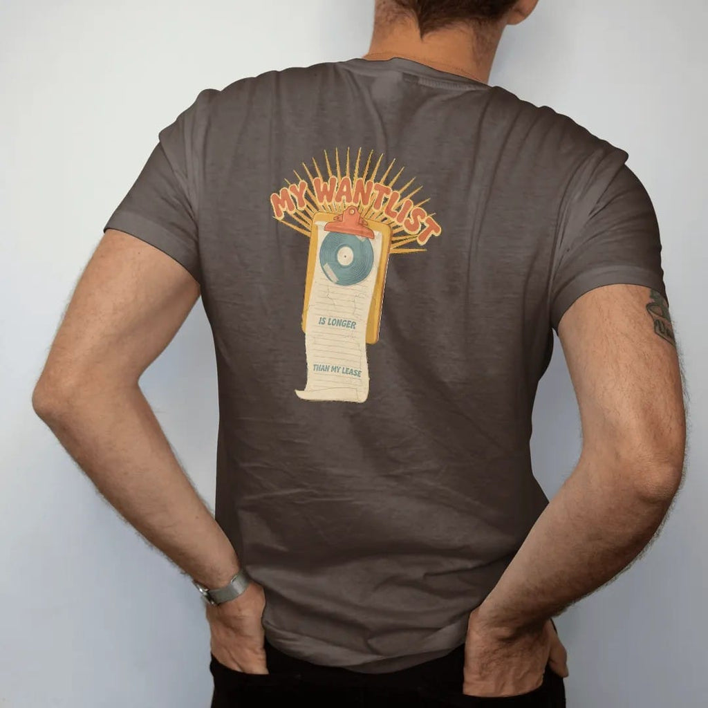 Man wearing a Espresso tee, seen from the back: a long paper wantlist unrolling from a clipboard, with "MY WANTLIST", "IS LONGER" and "THAN MY LEASE" in chunky 70s lettering and small 70s caps, printed in faded, cracked cream, mustard, burnt orange…