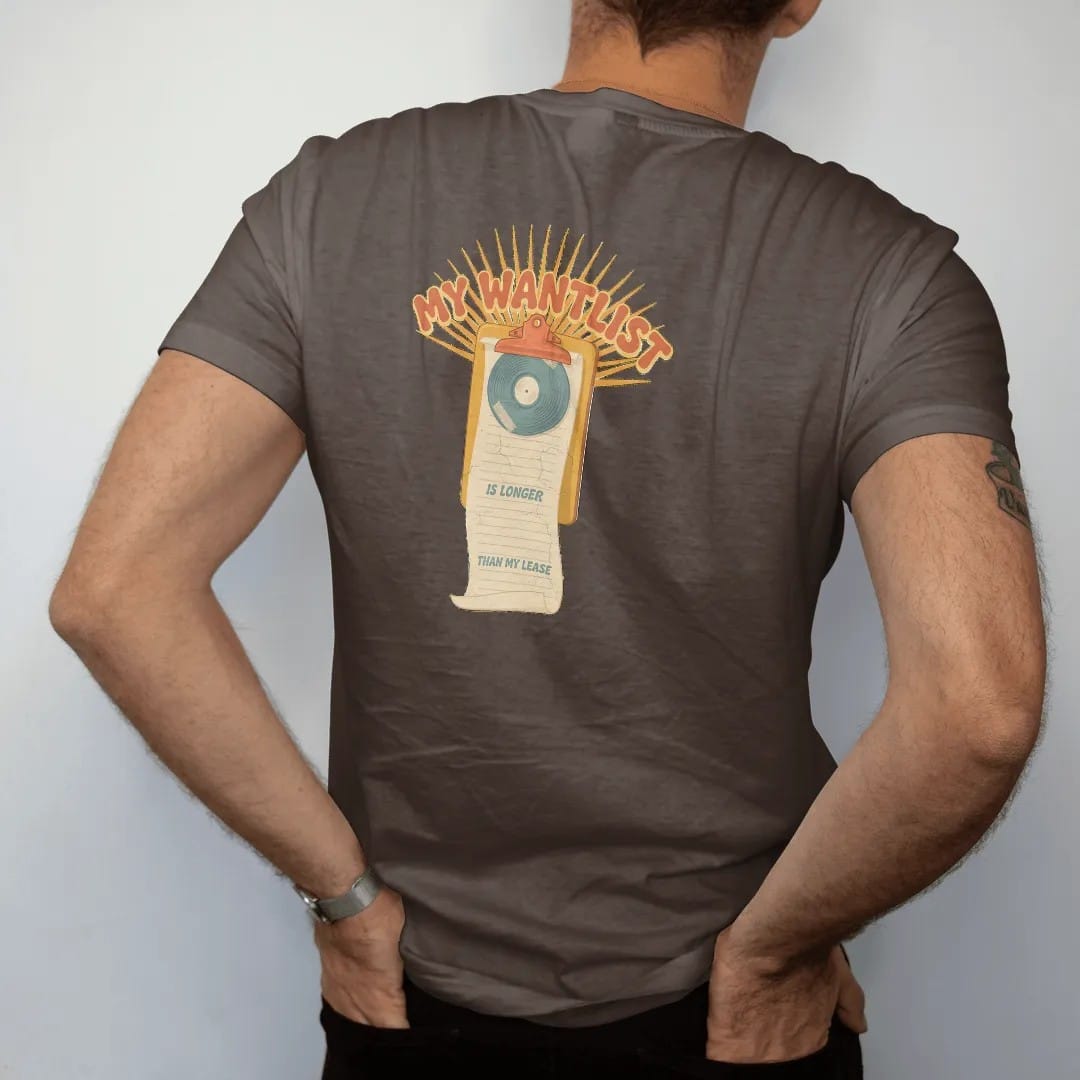 Man wearing a Espresso tee, seen from the back: a long paper wantlist unrolling from a clipboard, with "MY WANTLIST", "IS LONGER" and "THAN MY LEASE" in chunky 70s lettering and small 70s caps, printed in faded, cracked cream, mustard, burnt orange…