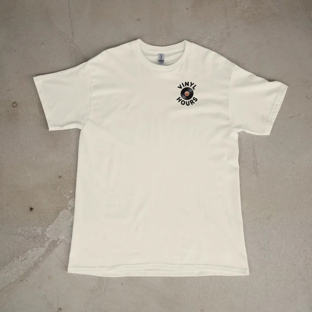 Front of a Ivory tee laid flat, with the small Vinyl Hours logo on the left chest.