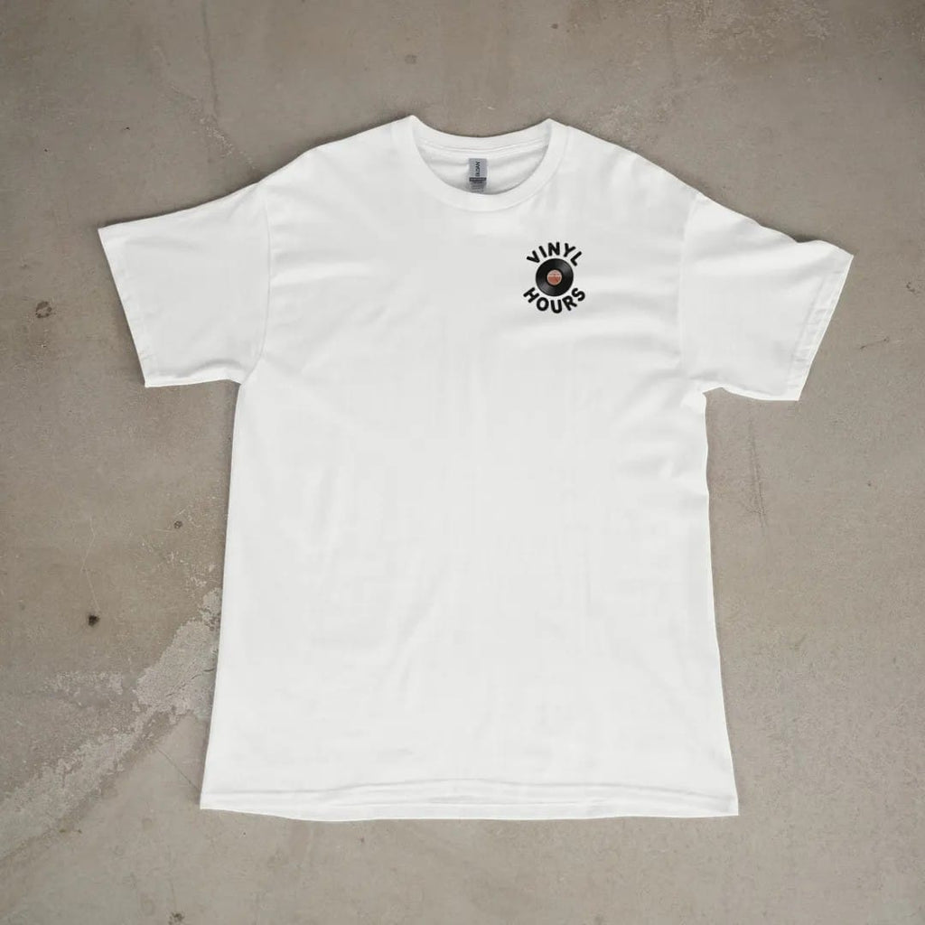 Front of a White tee laid flat, with the small Vinyl Hours logo on the left chest.